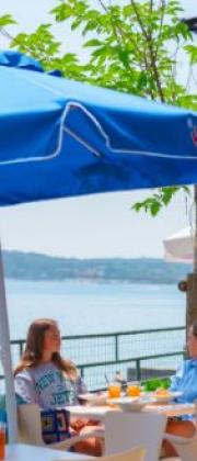 Two people sitting at a table with lake view.