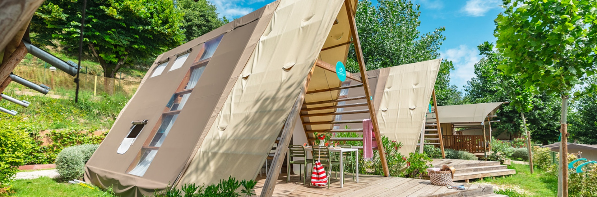 Cozy glamping tents surrounded by nature, perfect for a relaxing holiday.