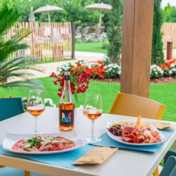 Outdoor lunch with rosé wine and charcuterie plates.